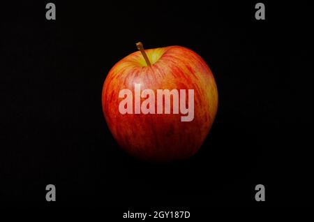 braeburn apple on dark black background Stock Photo