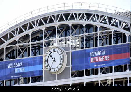 Manchester, UK, 6th October, 2021. 'Conservative Party slogans: 'Build Back Better' and 'Getting On With The Job' on the banner on the front of Manchester Central Convention Complex in city centre Manchester where the Conservative Party Conference is taking place 3rd October to 6th October, 2021. Credit: Terry Waller/Alamy Live News