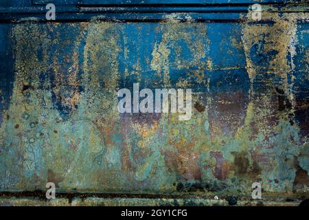 Blue and green and yellow patina painted on a wall textured background Stock Photo