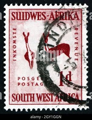 SOUTH WEST AFRICA - CIRCA 1954: a stamp printed in South West Africa shows Rock Painting of Two Bucks, circa 1987 Stock Photo