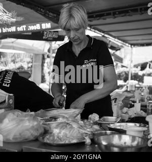 Sokobanja, Serbia, Aug 19, 2021: Woman working in a fast food restaurant kitchen (B/W) Stock Photo
