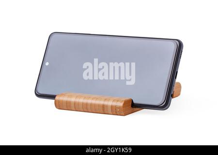 Smartphone on wooden stand isolated on white Stock Photo