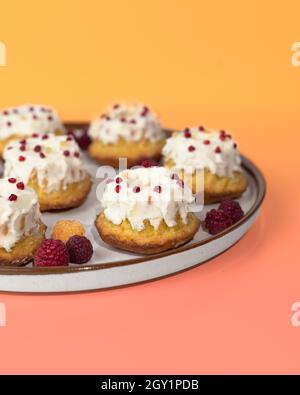 Homemade keto dessert donuts made from almond flour glazed with whipped cream. Gluten-free, low-carb baked goods. Stock Photo