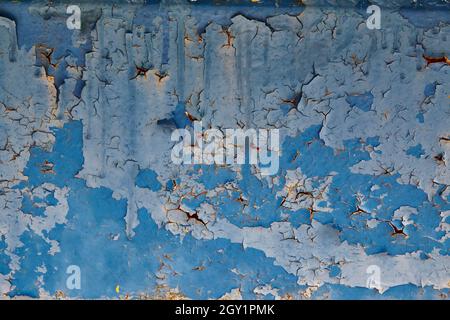 Abandoned blue wall with light blue and dark blue peeling paint background Stock Photo