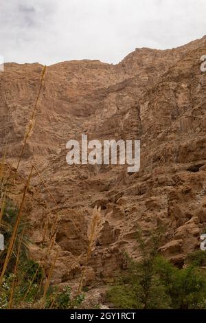 Wadi Shab river canyon with rocky cliffs in Sultanate of Oman Stock Photo
