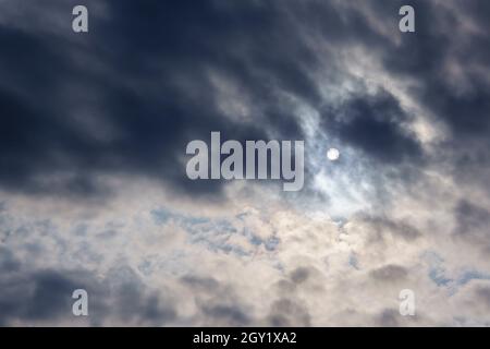 Cloudy weather, the sun through the clouds, gloomy depressive background Stock Photo