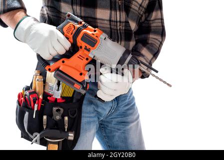 Carpenter worker at work holding rechargeable hammer drill, isolated on white background. Construction industry. Carpentry. Stock Photo