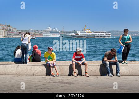 Istanbul, Turkey; May 26th 2013: People on the pier of the bay. Stock Photo