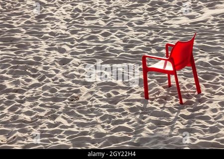 Red chair on the sand Stock Photo