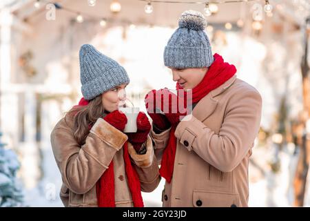 Happy man and woman warming up, drinking hot tea Stock Photo