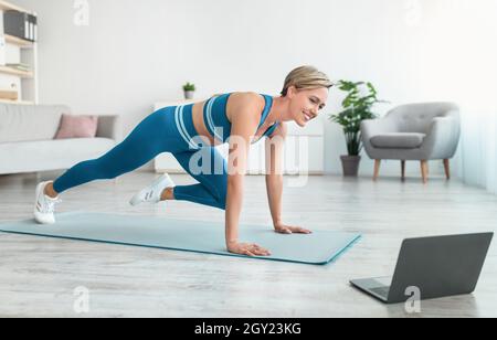 Woman Doing Cross Body Mountain Climbers Exercise Stock Photo