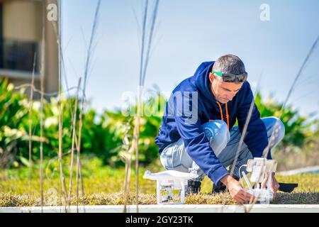 Man setting up his drone for flying over the beach Stock Photo