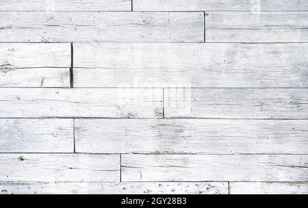 Crackled paint finish on white wood planks. Aged reclaimed barn wood. White antique faded rough wood surface. Stock Photo