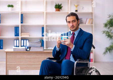 Young male disabled employee working in the office Stock Photo