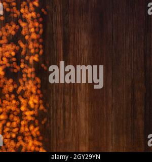 Bokeh lights on a wooden brown background with copy space, mockup for your design Stock Photo