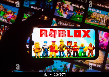In this photo illustration, the Roblox app seen displayed on a smartphone  screen and a Roblox logo in the background. (Photo by Thiago Prudencio /  SOPA Images/Sipa USA Stock Photo - Alamy