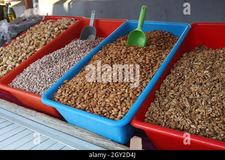 Nuts and beans in boxes for sale in the bazaar. Stock Photo