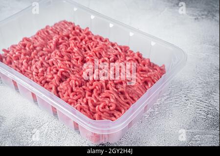 Fresh Raw mince beef and pork meat in vacuum packaging. White background. Top view Stock Photo