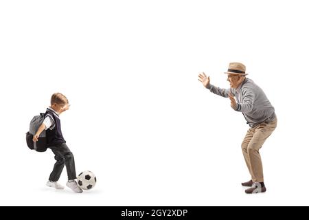 Grandfather and schoolboy playing football isolated on white background Stock Photo