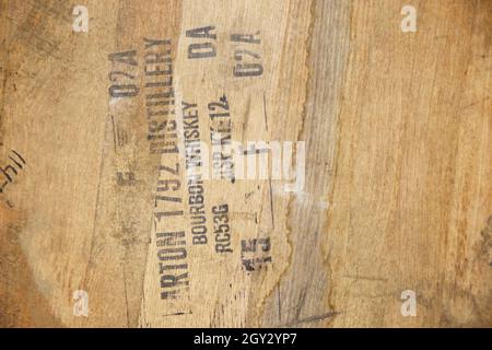 Texture of wood wine barrel up close with black stamp label Stock Photo