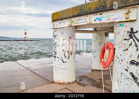 Close up of structure on pier with peeling paint and lake view Stock Photo