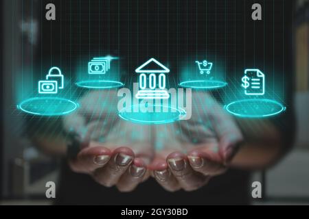 Online banking concept with futuristic design and graphics over hands. Financial icons as a projection of the image Stock Photo