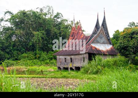 An old Minang house or Rumah Gadang with stilts above the ground in  the Harau Valley, West Sumatra, Indonesia. Stock Photo