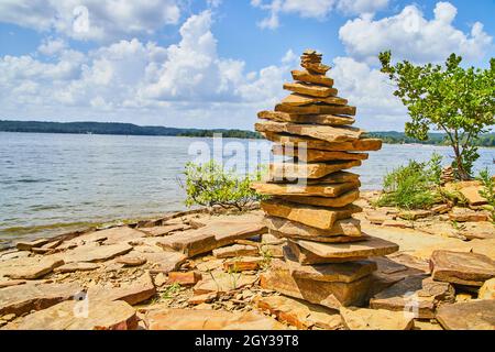 Tall and serene cairn stack of rocks on beach Stock Photo