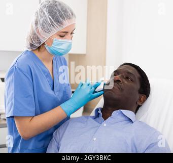 Man getting procedure of injection for face skin tightening Stock Photo