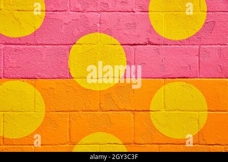 Cement block texture painted with orange and pink and yellow spots Stock Photo