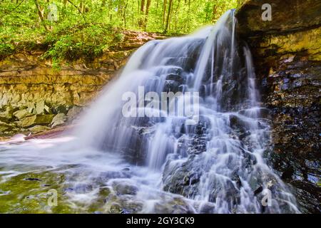 Landscape of white waterfall cascading over rocks up close Stock Photo