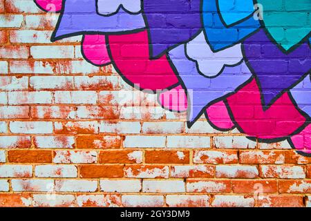Exposed white and red brick with colorful blue and purple flower painting Stock Photo