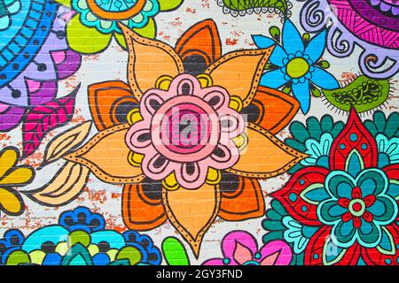 Colorful flower graffiti artwork on brick wall Stock Photo