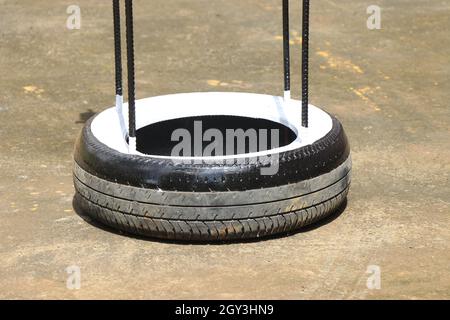 Old tire from a car attached with iron rods to make something useful, Waste rubber tire reuse concept Stock Photo