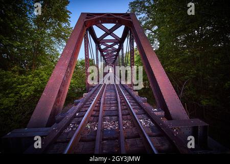 Wide and close view on train tracks of purple steel bridge Stock Photo