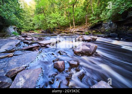 River cascading through and around rocks in small gorge Stock Photo