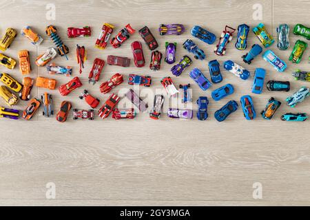 Top view random collection of model sport car toy hot wheels on wooden floor Stock Photo