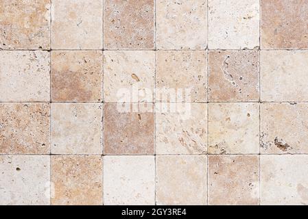 Natur stone wall from small square parts. Background or texture for interior. Stock Photo