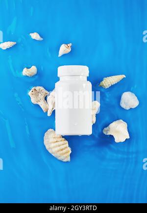 Jar mockup on blue background in water with waves and seashells. Stock Photo
