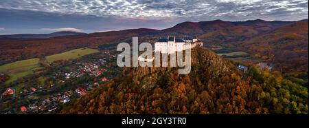 Fuzer, Hungary - Aerial panoramic view of the beautiful Castle of Fuzer with amazing colorful sunrise sky and clouds on an autumn morning. The castle Stock Photo