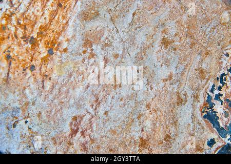 Texture of rock up close with rust colors and dark gray spots Stock Photo