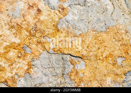 Texture of stone surface up close with grey and yellow colors Stock Photo
