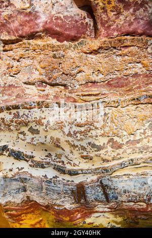Texture detail of rock with layers of orange and red Stock Photo