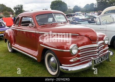 Naphill, England - August 29th 2021: A red Plymouth Special Deluxe Coupe. The model was built between 1946 and 1950. Stock Photo