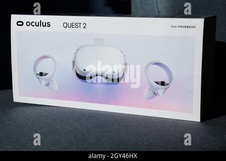 Child holds new VR head set box. A new generation gaming device for entertainment and sport. Oculus Quest 2. Stock Photo