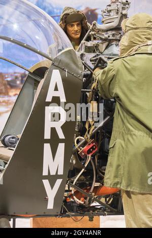 A Bell H-13E Sioux helicopter during a snowy winter in the Korean war. The same copter from the MASH TV show. At the US Army Transportation Museum at Stock Photo