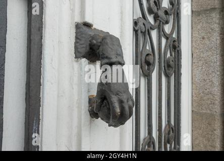 Hand Shaped Door Knocker on building in Galicia, Spain. Stock Photo