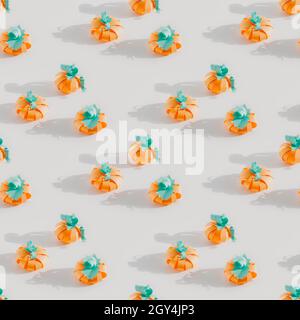 Seamless pattern with craft paper pumplin on white background. Bright sunny light, long shadows, isometric view Stock Photo