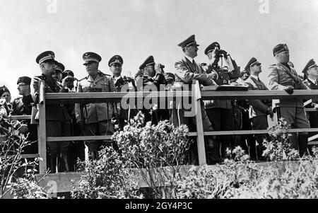 From left: King of Italy Viktor Emanuel, Marshal Badoglic, Heinrich Himmler, Adolf Hitler, Wilhelm Keitel, Rudolf Heß, Benito Mussolini, Joachim von Ribbentrop at the observation post in Santa Marinella, Italy. The gentlemen are observing a military training maneuver in which an infantry assault is simulated. [automated translation] Stock Photo