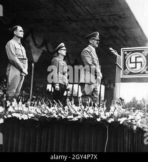 'Hitler addresses the crowd at the ''Greater Germany'' party conference in 1938. Behind him his deputy Heß and the Reich Youth Leader Baldur von Schirach, who was always present on such occasions when groups of Hitler Youth marched up. [automated translation]' Stock Photo